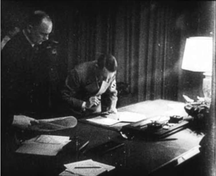 А.Гитлер подписывает Мюнхенское соглашение. 29 сентября 1938 года.